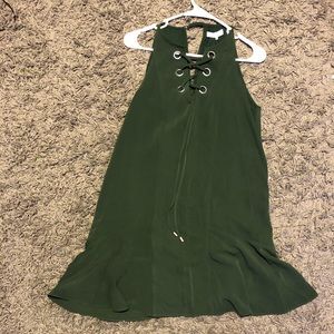 Dark green dress with lace up detail.